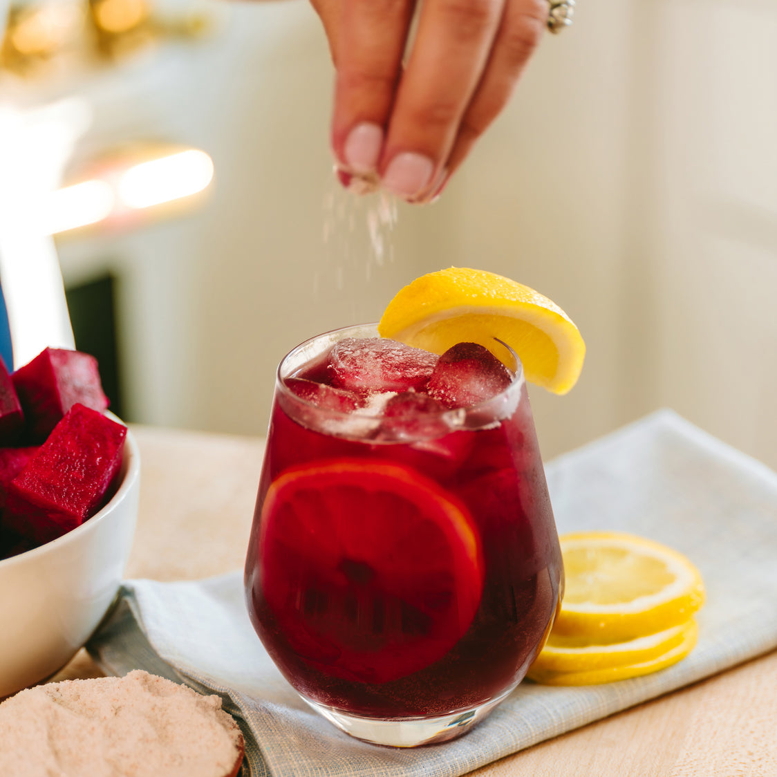 Glass of beet root and ginger hydration drink, sprinkled with Celtic Pink Cave Salt